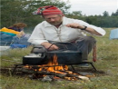 Cliff Speer checks if the water is ready for tea and wild rice.